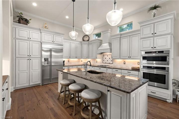 New light & bright with all stainless appliances, wood flooring & crown molding