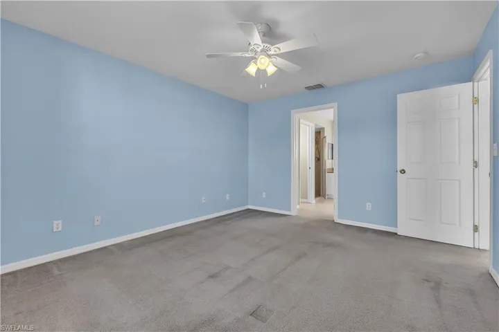 Unfurnished bedroom with a ceiling fan and carpet floors