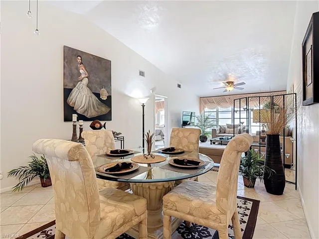 This interior features a dining area with tiled flooring and a glass-top table