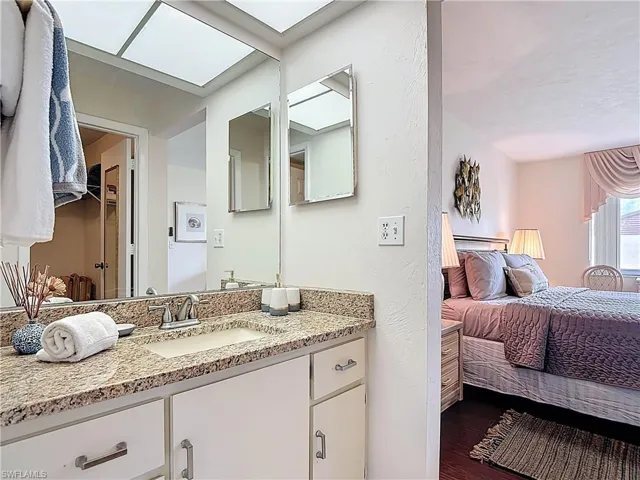 The property features a bathroom vanity with a granite countertop and a built-in sink