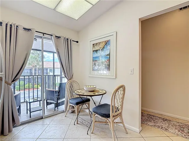 The property features a dining area with tiled flooring, leading to a screened-in balcony