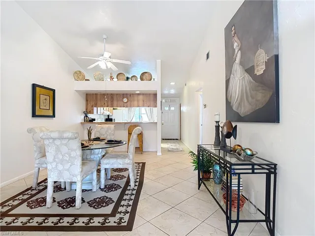 The main living area features vaulted ceilings, tile flooring, and a ceiling fan