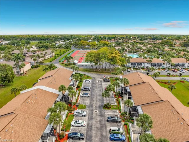 Aerial view showcasing the property's proximity to a tennis court and a swimming pool