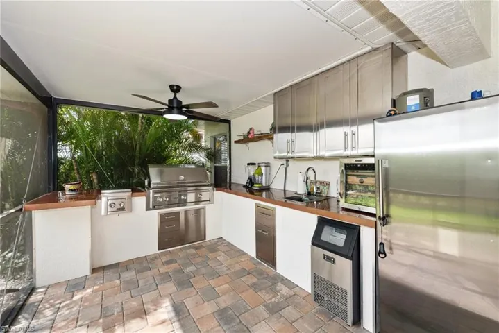 View of patio / terrace featuring ceiling fan and area for grilling