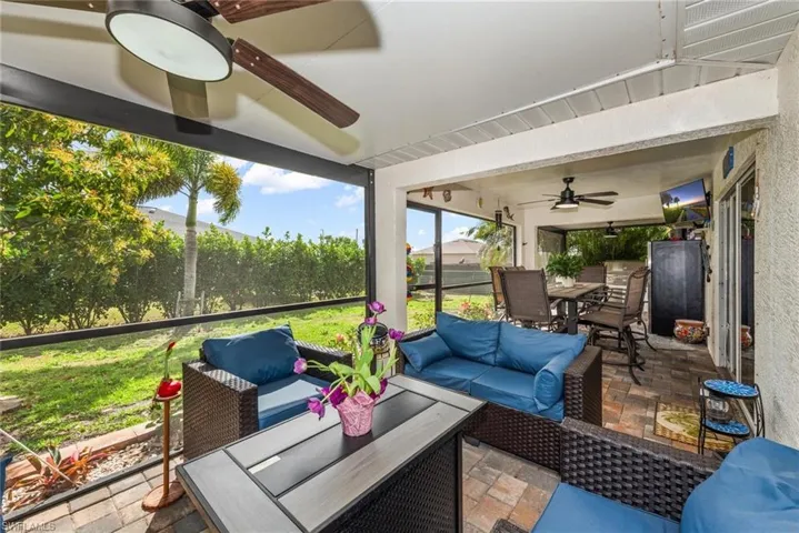 Sunroom / solarium with ceiling fan, outdoor lounge area, and a patio