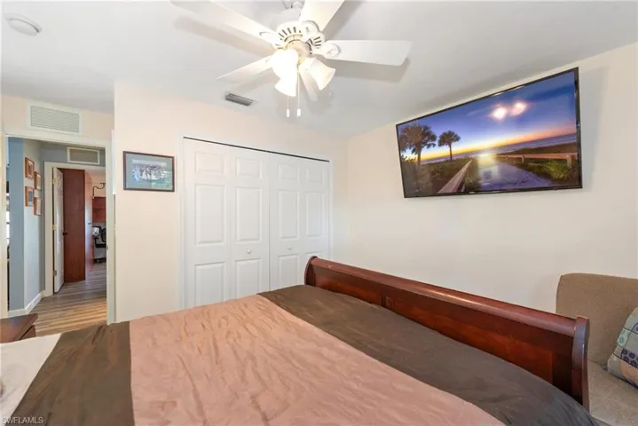 Bedroom featuring a ceiling fan and a closet