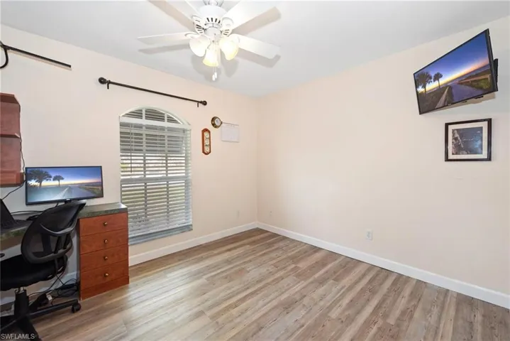 Unfurnished office featuring light wood-style flooring and ceiling fan