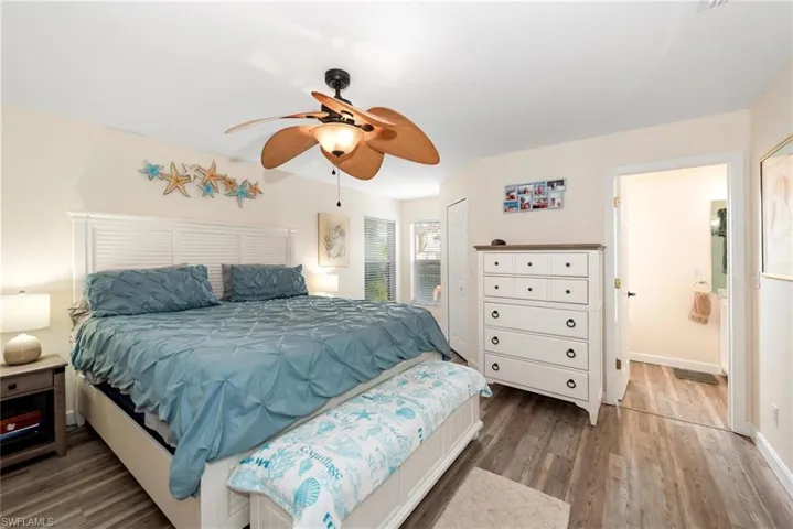 Bedroom featuring dark wood-style floors and a ceiling fan