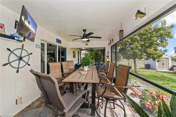 Sunroom featuring outdoor dining space and ceiling fan
