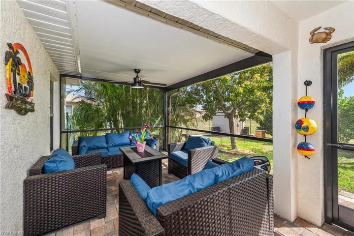 Sunroom featuring a ceiling fan and outdoor furniture