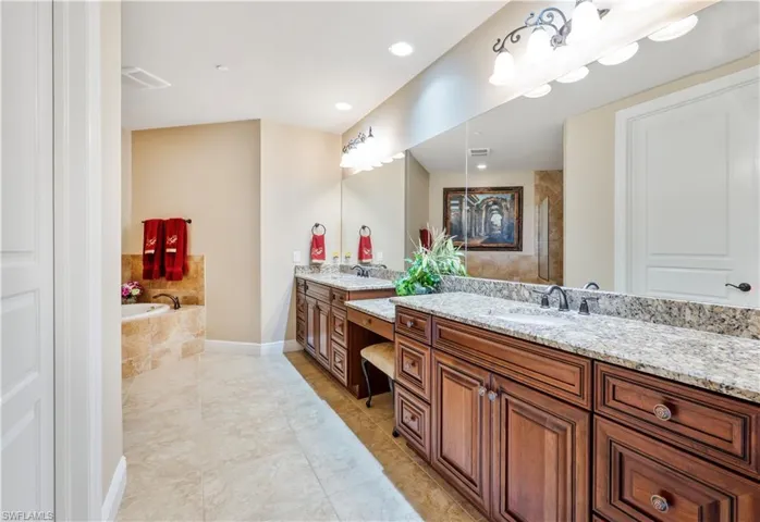 Dual sinks, vanity area & a giant walk-in closet.