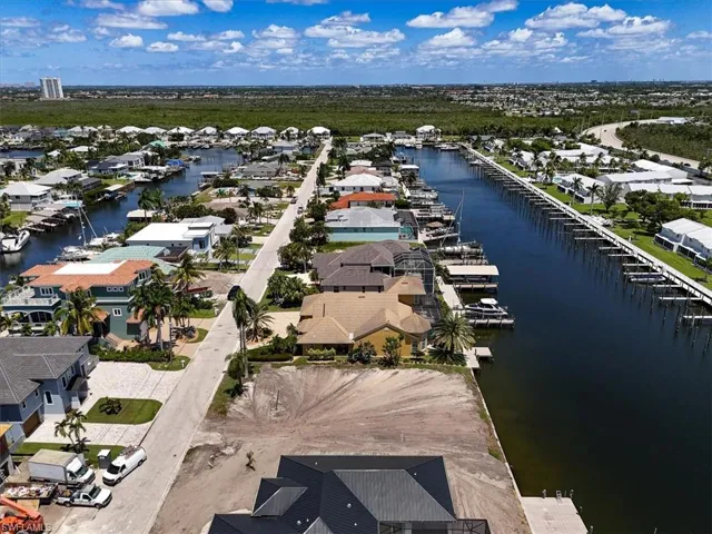 Waterfront property with direct canal access, an existing dock, and a clear, level lot ready for development