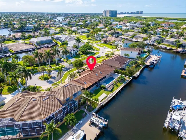 Birds eye view of property with a water view