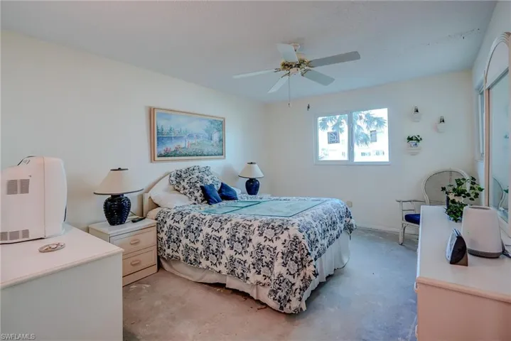 Bedroom with ceiling fan and baseboards