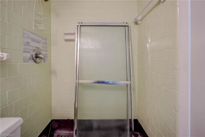 Bathroom with a stall shower and toilet