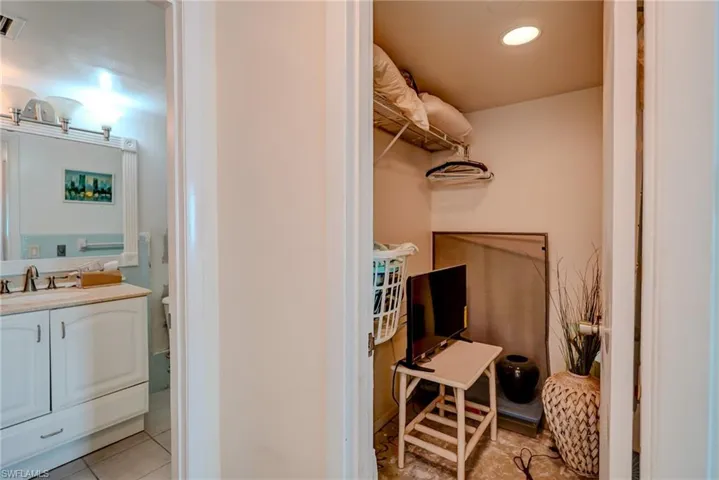 Bathroom with vanity, light tile patterned floors, and recessed lighting