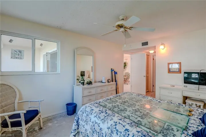 Bedroom featuring ceiling fan and baseboards