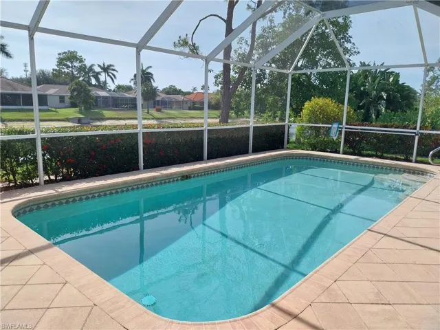 Swimming pool with a lanai and a residential view