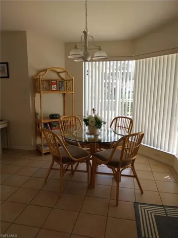 Dining area featuring a chandelier and light tile patterned flooring