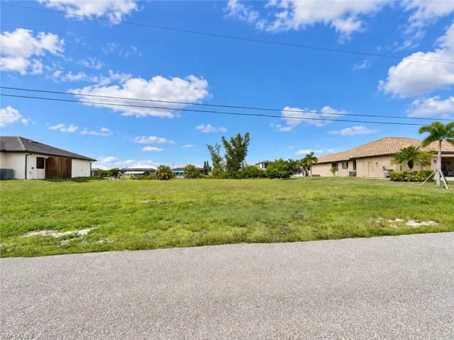 Expansive lot featuring a clear, grassy area