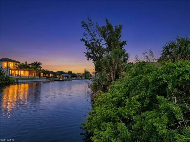 Waterfront property with established landscaping and mature palm trees