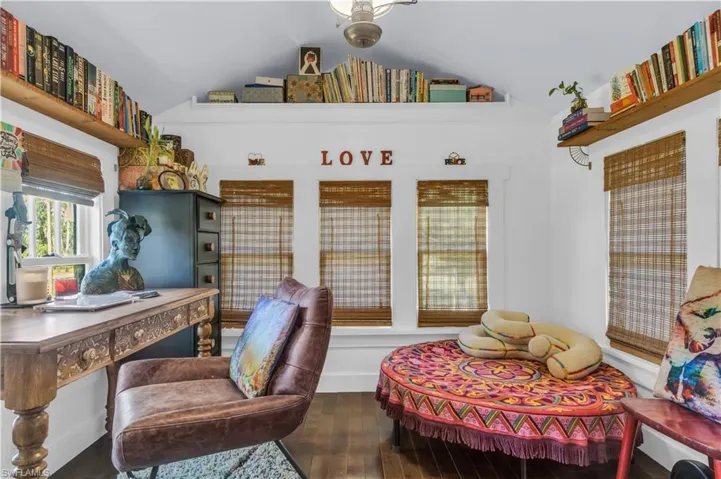 Home office with vaulted ceiling and maple wood flooring