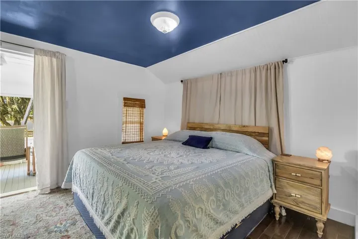 Master bedroom featuring lofted ceiling and maple wood flooring