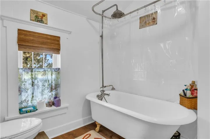 Master bathroom featuring clawfoot tub with rain shower