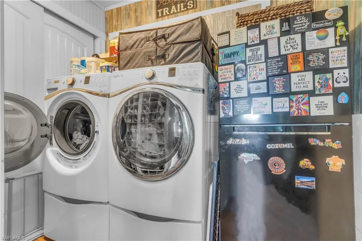 Laundry room with washer and dryer and crown molding