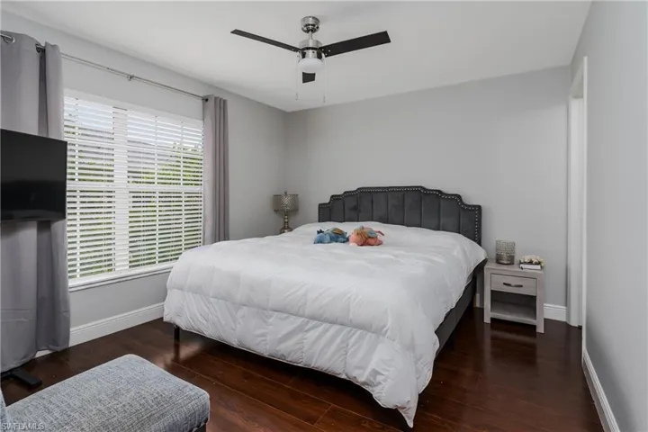 Bedroom featuring dark wood-style flooring and ceiling fan