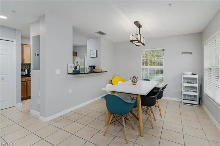 Dining room featuring light tile patterned floors and baseboards