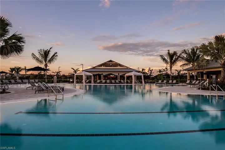 Pool at dusk featuring a gazebo and a patio area