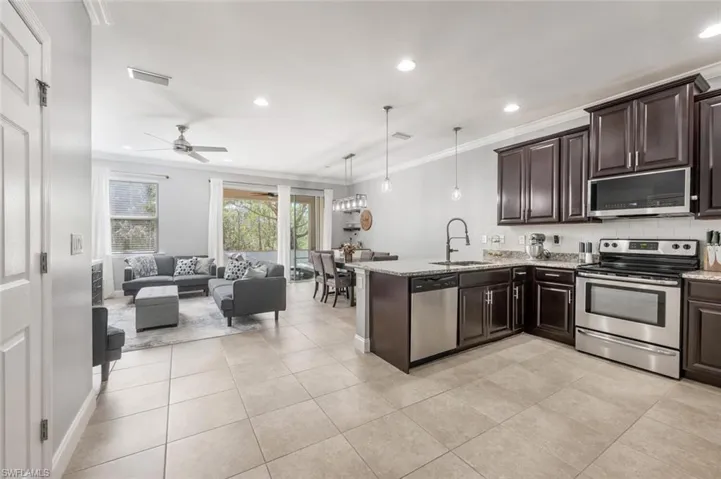 Stylish dark cabinets and backsplash.
