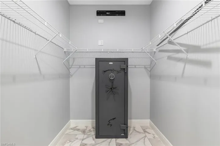 Walk in closet featuring marble finish floor
