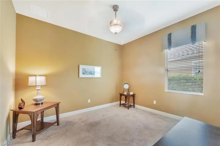 Sitting room featuring carpet flooring and a ceiling fan