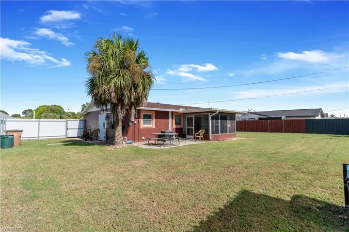 View of yard with a patio area and a sunroom
