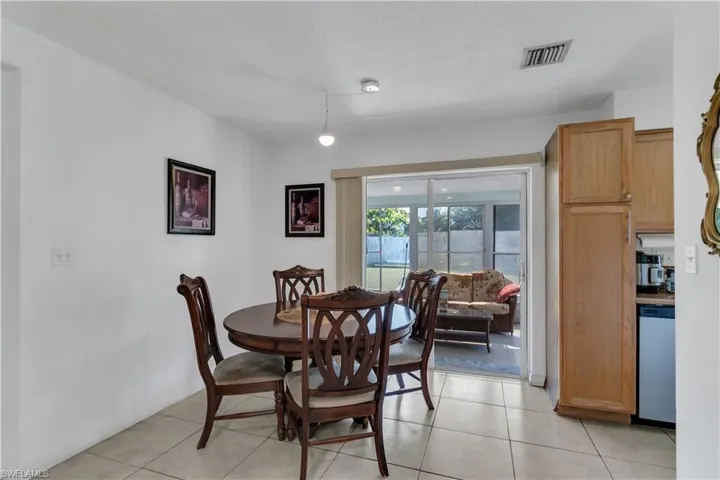 Dining room with light  patterned floors and a textured ceiling
