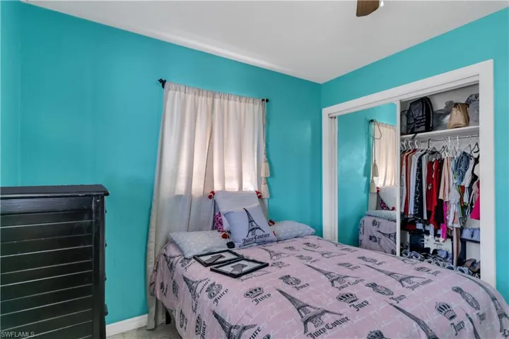 Bedroom with ceiling fan and a closet