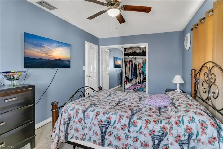Bedroom with ceiling fan and a closet