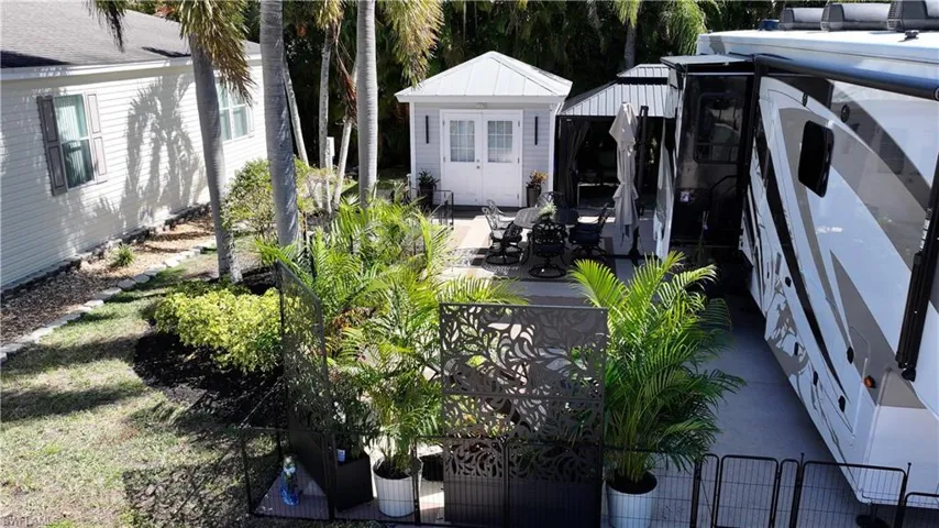 View of yard featuring a patio area, a gazebo, an outdoor structure, and a gate