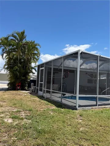 View of the screened-in pool enclosure, providing a private outdoor oasis