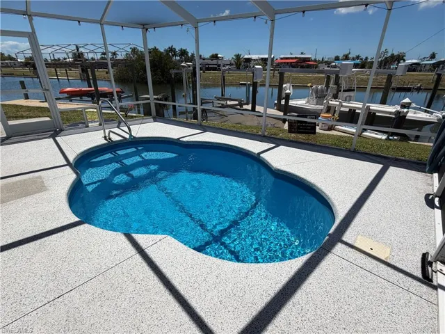 The property features a screened-in pool with a unique shape, offering a private outdoor living space