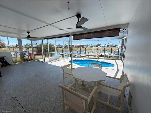 Spacious screened-in patio and entertaining area with direct views of the canal and pool