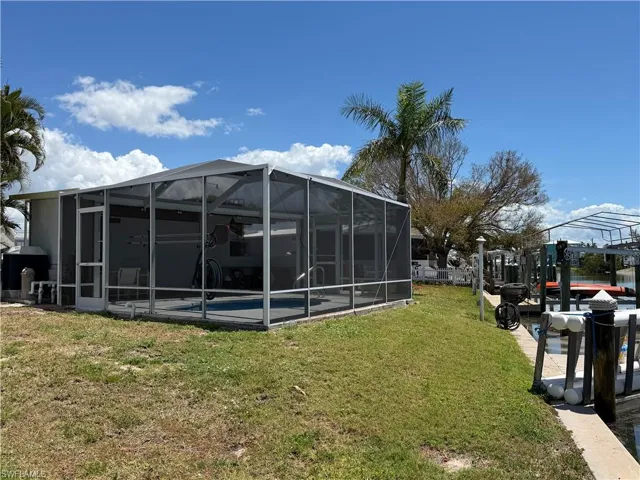 Dockside view of the waterfront and screened in lanai with pool