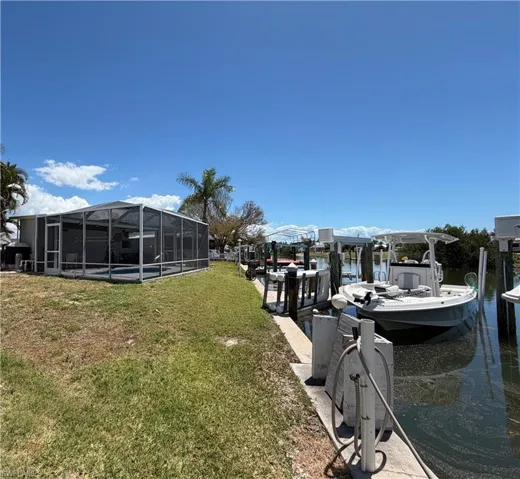 Waterfront view of two boat lifts and dock area