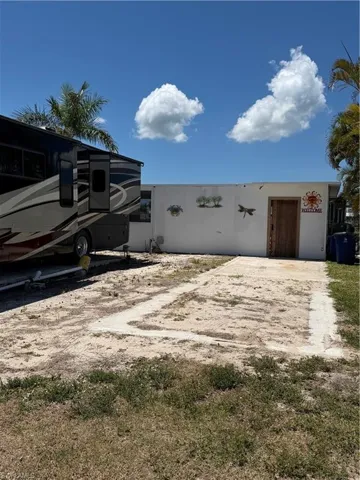 View of the existing enclosed lanai and pool area from the street.