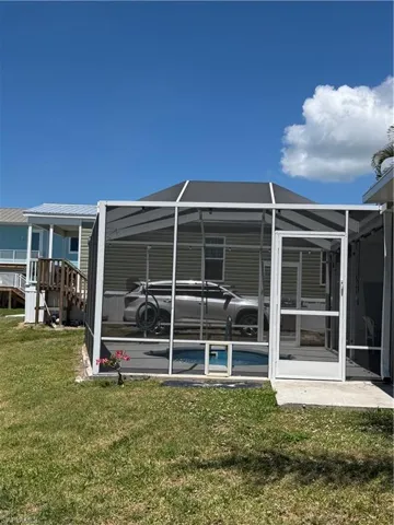 The property features a screened enclosure with a pool