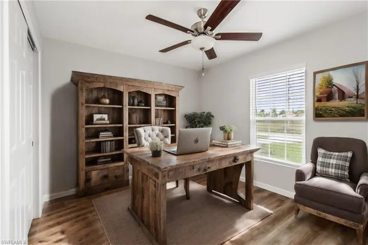 Office space featuring ceiling fan and dark hardwood / wood-style flooring