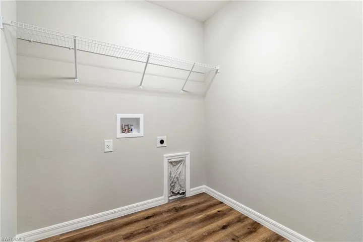 Clothes washing area featuring hardwood / wood-style floors, electric dryer hookup, and hookup for a washing machine