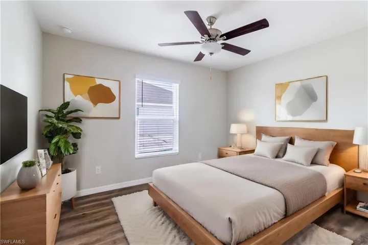Bedroom featuring dark hardwood / wood-style floors and ceiling fan